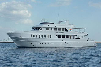 the liveaboard My Jessica, a white multi-deck dive boat, anchored at sea
