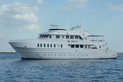 the liveaboard My Jessica, a white multi-deck dive boat, anchored at sea