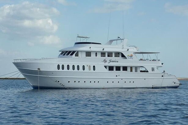 the liveaboard My Jessica, a white multi-deck dive boat, anchored at sea