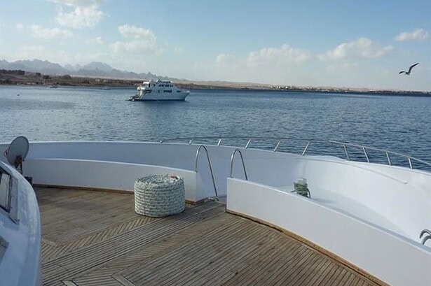 Bow deck of the My Jessica overlooking calm Red Sea water with another liveaboard boat anchored nearby