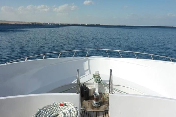 Bow of the My Jessica liveaboard with coiled mooring rope on deck facing open Red Sea water