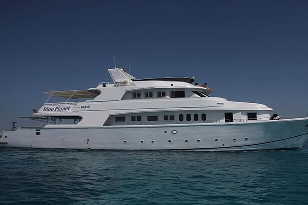 Side view of the Blue Planet 1 liveaboard underway on calm blue water