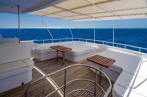 Shaded sun deck lounge on the Blue Planet 1 liveaboard with wraparound seating over the Red Sea