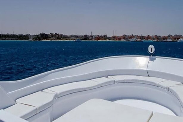 Curved white bow seating on the Blue Planet 1 with the Egyptian coastline in the background