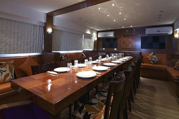 Dinner table set with plates and glasses in the Blue Planet 1's dining saloon