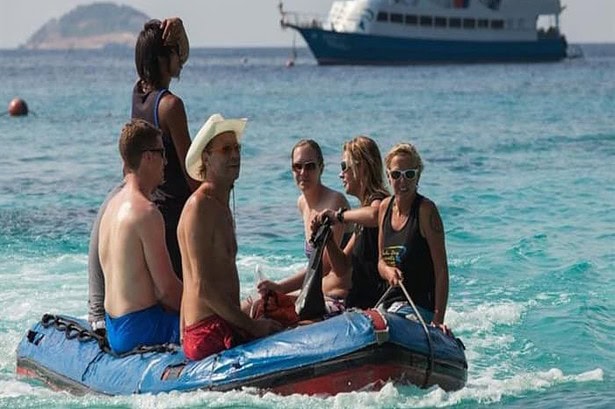Guests riding an inflatable tender back to the Similan Explorer liveaboard after a beach stop