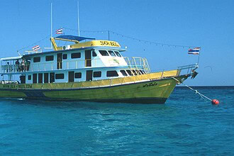 the liveaboard Sea Bees, a yellow and white dive boat, underway at sea