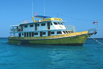 the liveaboard Sea Bees, a yellow and white dive boat, underway at sea