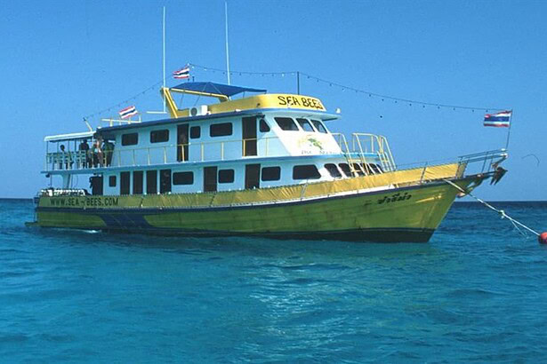 the liveaboard Sea Bees, a yellow and white dive boat, underway at sea