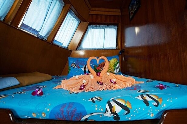 Honeymoon cabin bed aboard the MV Marco Polo decorated with towel swans and flowers