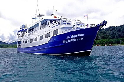 Manta Queen 7 liveaboard boat anchored off Thailand's coast, seen from the bow