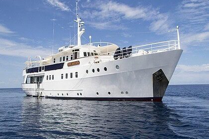 Pelagian liveaboard yacht at anchor in calm blue water