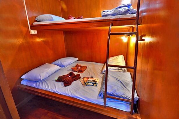 Lower bunk on Manta Queen III made up with folded towels and a dive magazine on the pillow