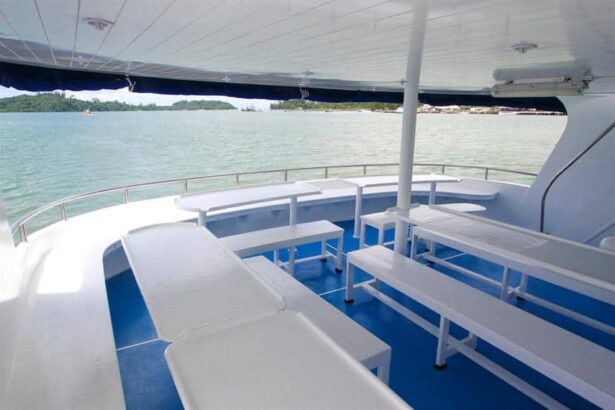 Open-air lounge deck on Manta Queen III with cushioned bench seating overlooking the harbour
