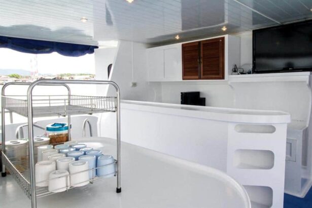 Indoor dining area on Manta Queen III with a drinks cart, cabinetry and a wall-mounted TV