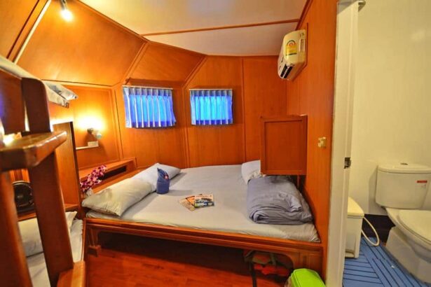 Manta Queen III's master cabin with a double bed and an ensuite bathroom visible through the door