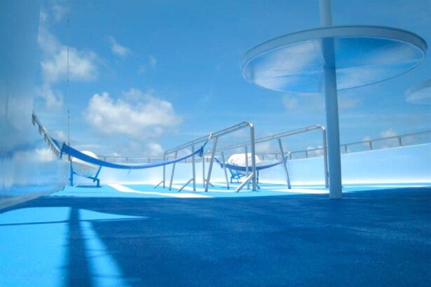 Empty hammocks strung along the sun deck of the Manta Queen 3 liveaboard under blue sky
