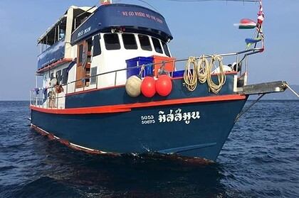 The Miss Moon liveaboard's dark blue hull and rigged foredeck, its motto painted across the top