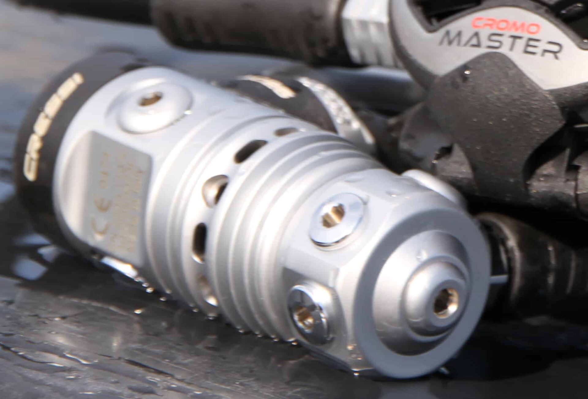 Close-up of the Cressi AC25 Master Cromo first stage turret and low-pressure ports, wet after testing