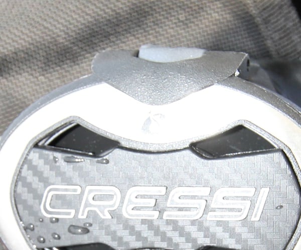 Close-up of the venturi lever on top of the Cressi AC25 Master Cromo second stage, still wet from a test dive
