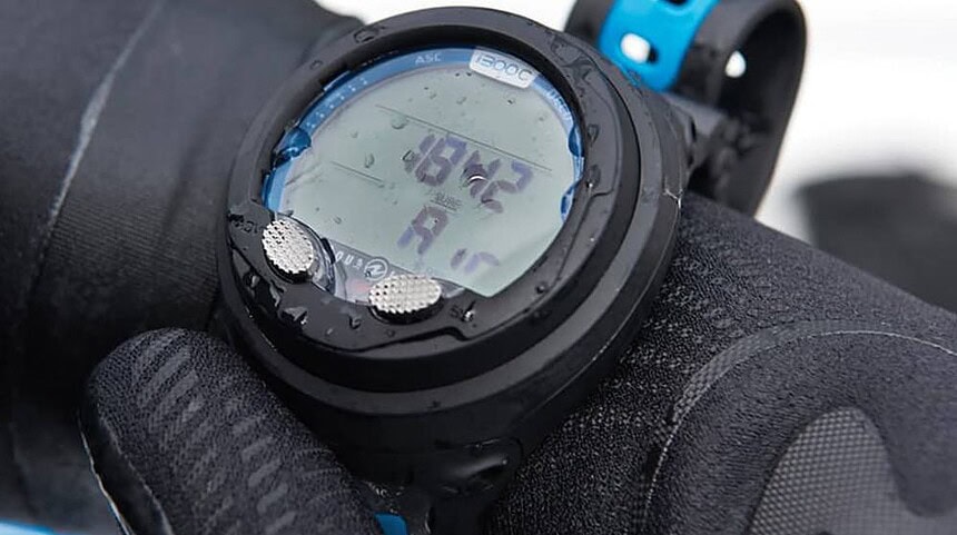 Aqua Lung i300c On A Gloved Wrist Close-up of the Aqua Lung i300c on a gloved wrist, screen beaded with water after a dive