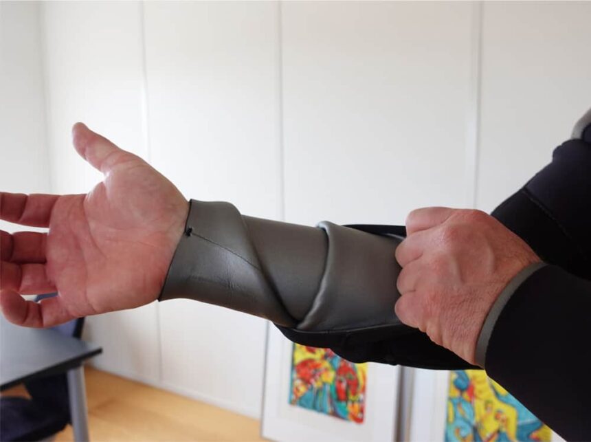 Northern Diver 7mm Wrist Seal Our tester stretching the smooth-skin neoprene wrist seal on the Northern Diver 7mm semi-dry wetsuit