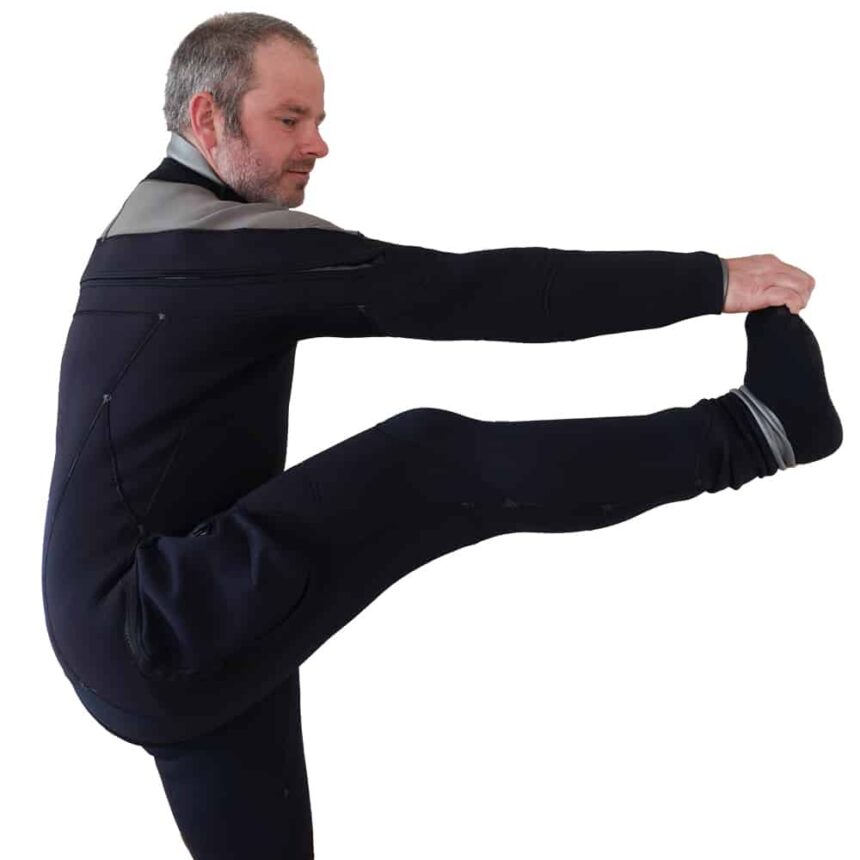 Northern Diver 7mm Wetsuit Flexibility Diver in the Northern Diver 7mm semi-dry wetsuit holding a standing leg stretch on a white background