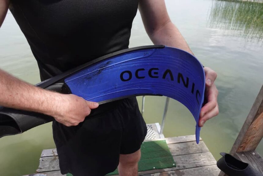 Flexing The Oceanic Predator Blade Our tester bending the blue Oceanic Predator blade into a deep curve on a lake dock