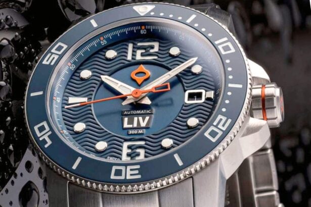 Close-up of the LIV GX Diver 41mm with blue wave-textured dial, orange seconds hand and steel bracelet