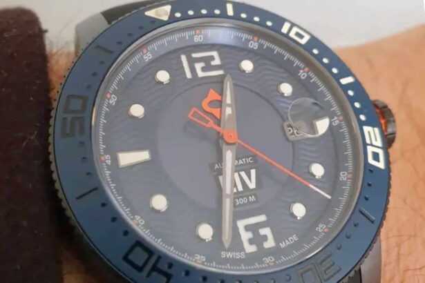 Close-up of the LIV GX Diver's navy dial, magnified date window and orange seconds hand on the wrist