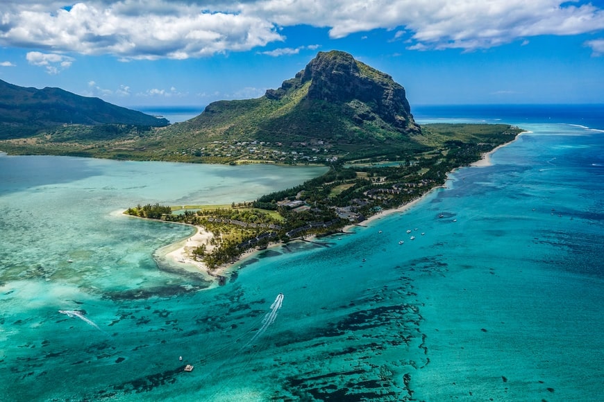 aerial view of Mauritius coastline with Le Morne mountain and turquoise lagoon