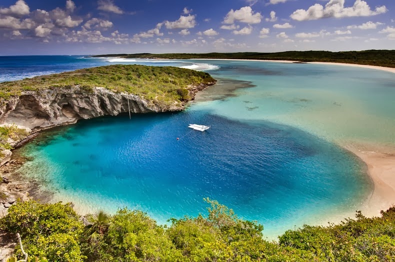 aerial view of Dean's Blue Hole with a boat anchored in the deep blue water