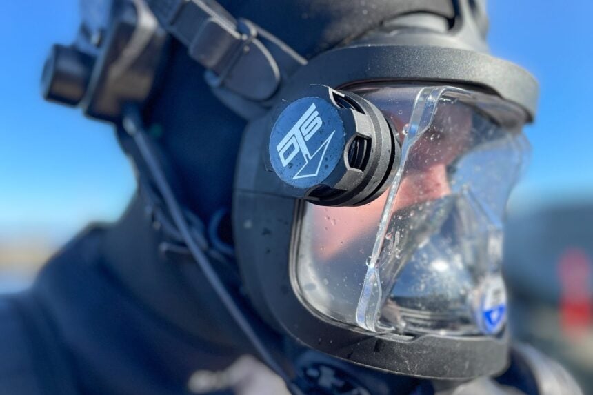 OTS Guardian Ambient Breathing Valve Close side view of the blue OTS valve cap on the Guardian full face mask, water beading on the lens