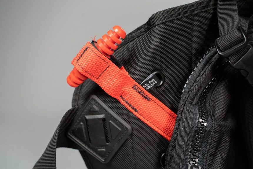 Ranger Orange Weight Release Pull Orange pull tab on the Zeagle Ranger weight pocket next to the zipper and shoulder strap