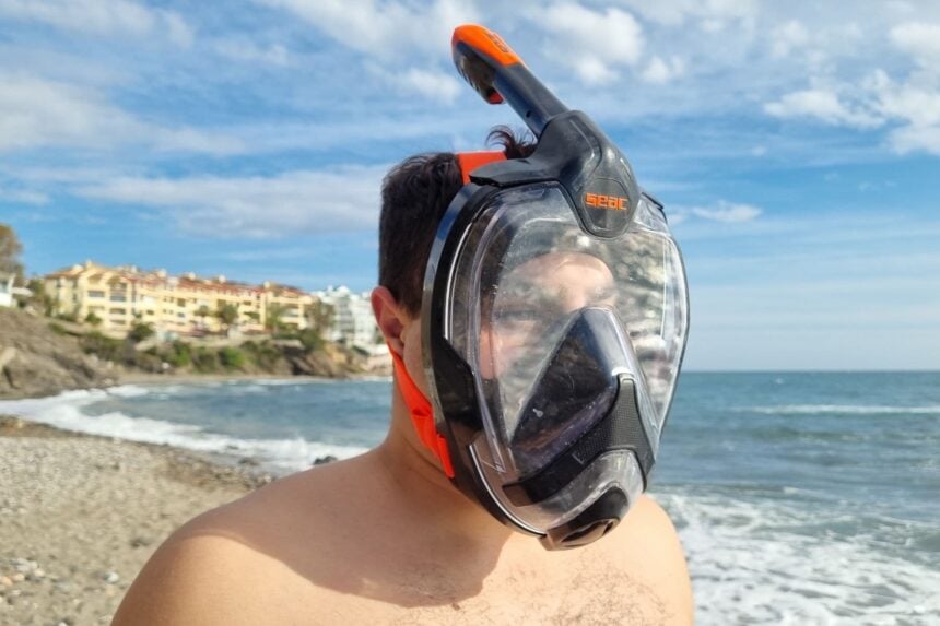 SEAC Unica Mask Side Profile On Beach Our tester wearing the SEAC Unica full face snorkel mask at the shoreline, side view with the sea behind