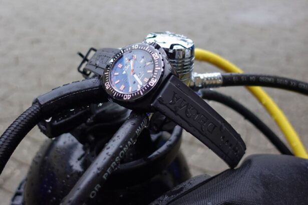 Delma Shell Star Black Tag dive watch resting on a wet scuba regulator beside a yellow hose
