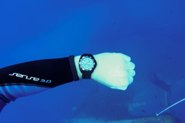 Delma dive watch on our tester's outstretched wrist against open blue water