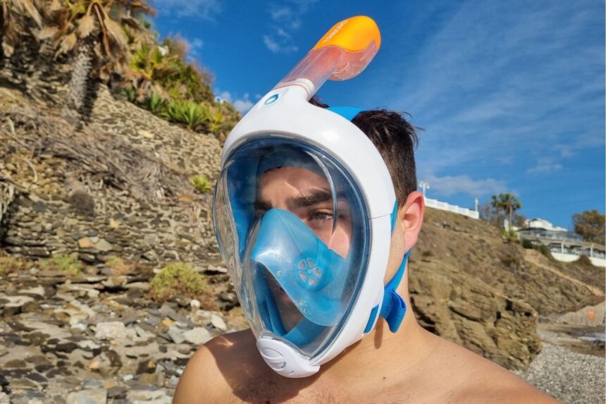 DIVEIN tester wearing the Subea Easybreath full face snorkel mask on a rocky beach