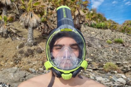 Our tester wearing the Mares Sea VU Dry Plus full face snorkel mask on a rocky shore