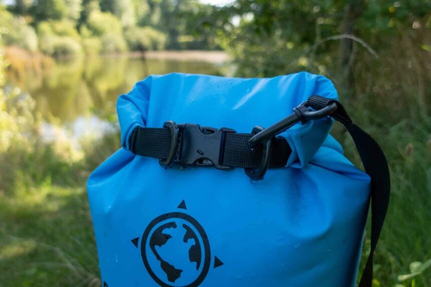 top roll closure and buckle of a blue Earth Pak waterproof dry bag