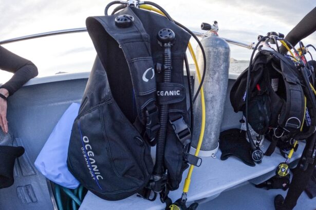Oceanic Oceansport BCD hanging on a boat rail next to a rigged tank and other dive gear