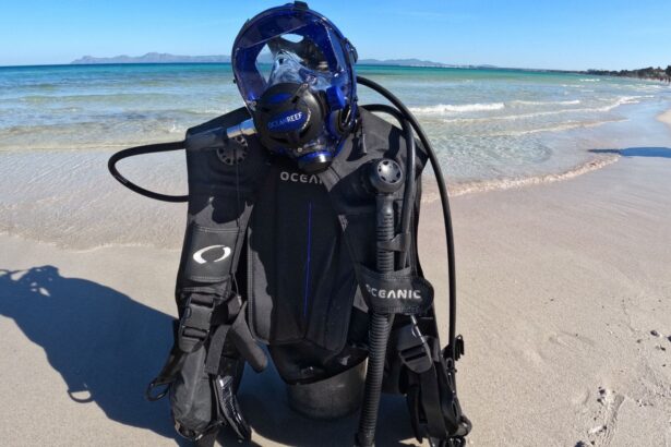 Oceanic Oceansport BCD rigged with a tank and a blue full face mask standing on a beach