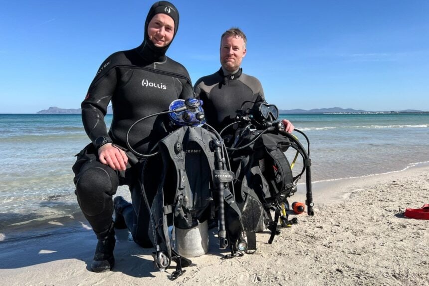 Oceanic Oceansport BCD Beach Test DIVEIN testers kneeling on the beach with two Oceanic Oceansport BCDs rigged to cylinders