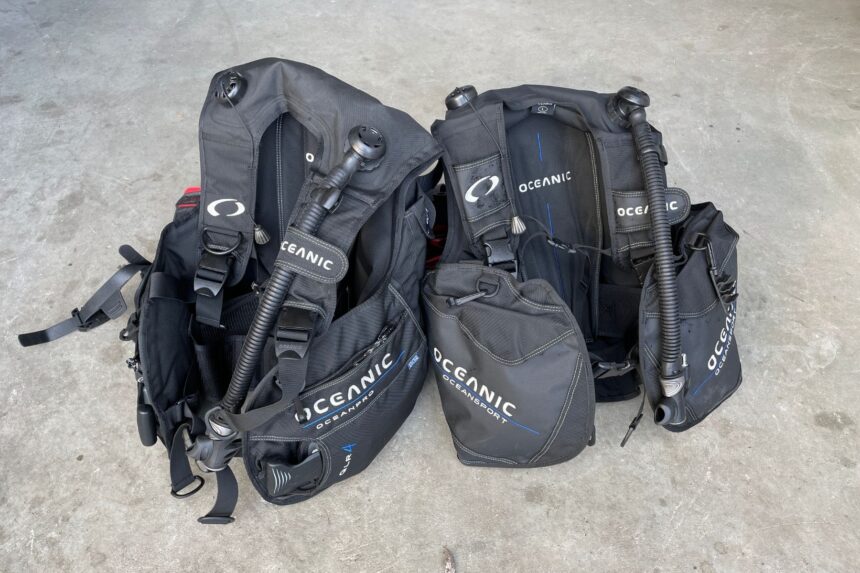 Two Oceanic Oceansport BCDs Compared Two Oceanic Oceansport BCDs laid out on a concrete floor with their octo pockets and inflator hoses