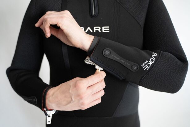 Our tester opening the wrist zipper on the sleeve of the Bare Evoke 7mm wetsuit