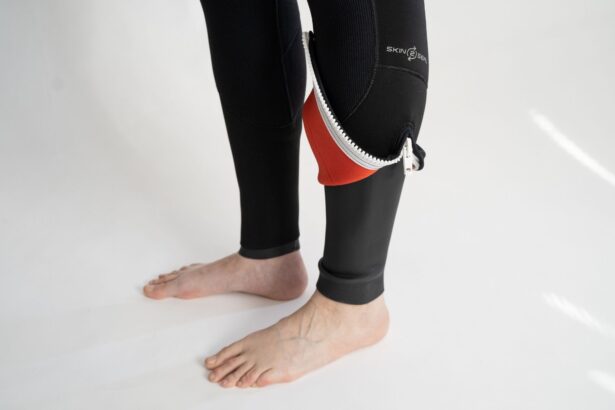 Open ankle zipper on the Bare Evoke wetsuit leg, showing the red inner lining