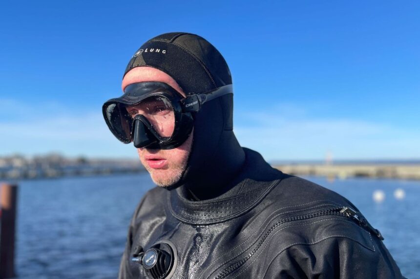 Cressi F1 Worn Over a Dive Hood DIVEIN tester wearing the Cressi F1 frameless mask over a neoprene hood before a cold water dive