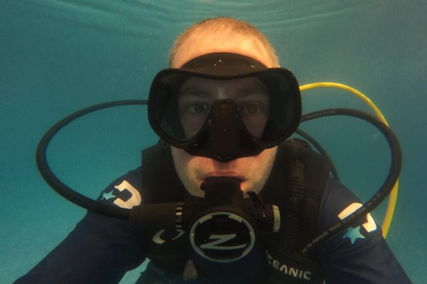 Zeagle Scope Mono Worn Underwater Our tester underwater in a pool wearing the Zeagle Scope Mono mask with a regulator in his mouth
