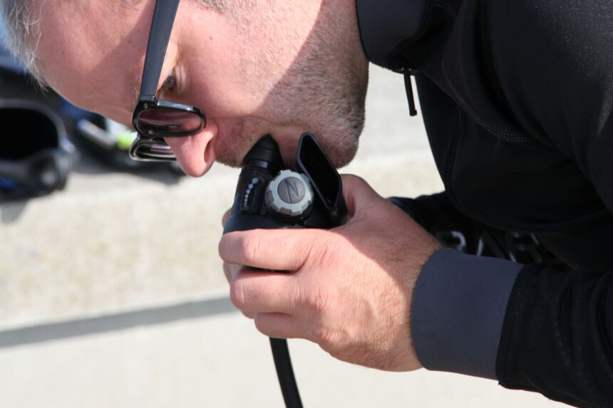 Dive Regulators DIVEIN tester biting into a regulator mouthpiece to check its air flow