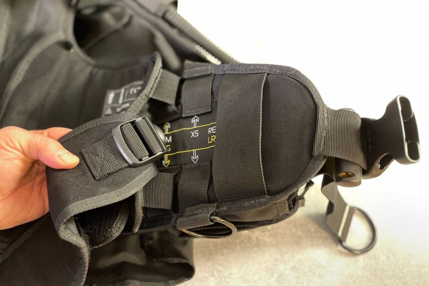 Hand holding the Zeagle Fury shoulder strap to show the printed size markings on the band